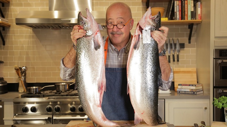 Andrew Zimmern holding fish