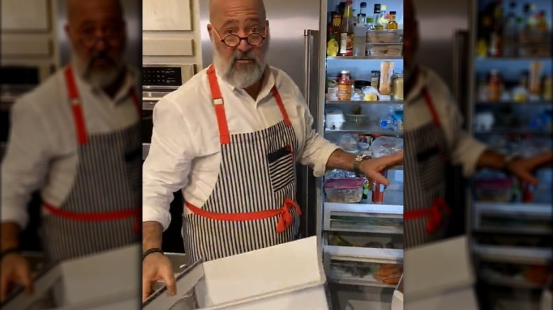 Andrew Zimmern taking a drawer out of a fridge