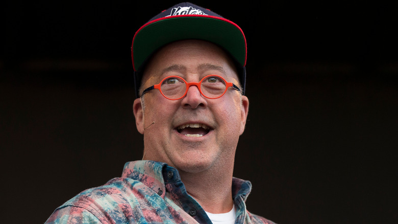 Andrew Zimmern in red glasses