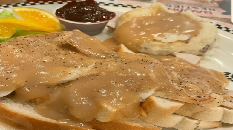 Turkey on white bread and smothered in gravy