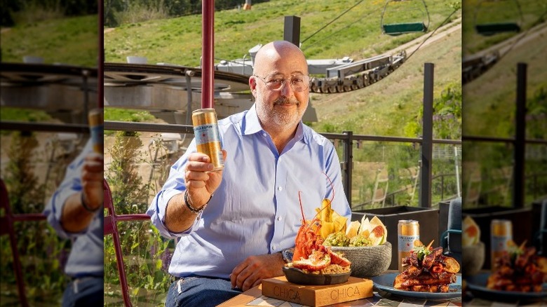 Andrew Zimmern enjoying a meal and a beer