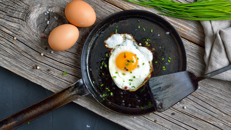 Perfect fried egg in frying pan with spatula