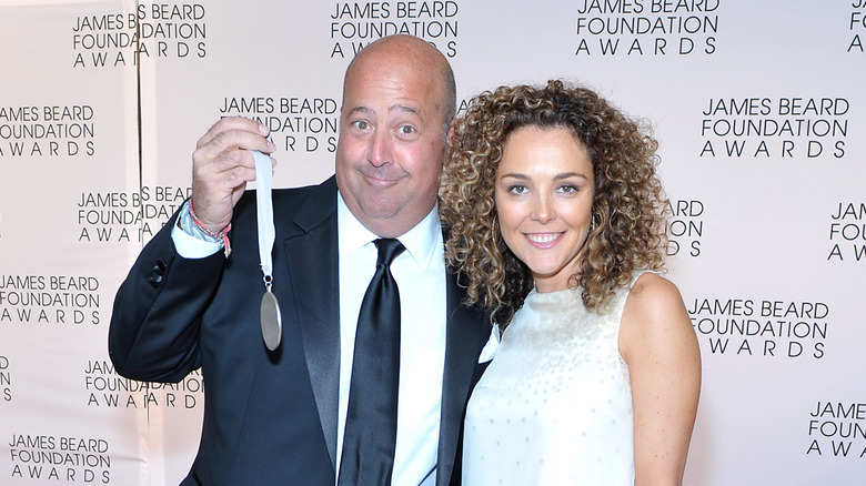 Andrew Zimmern holding a medal on the carpet of the James Beard Foundation Awards