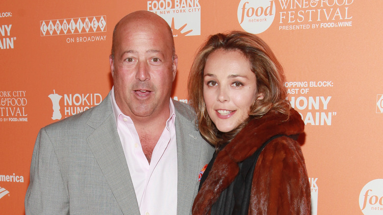 Andrew Zimmern and ex-wife Rishia posing at a Food Bank event