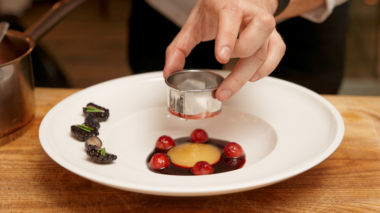 Chef uses metal cooking rings for perfect plating