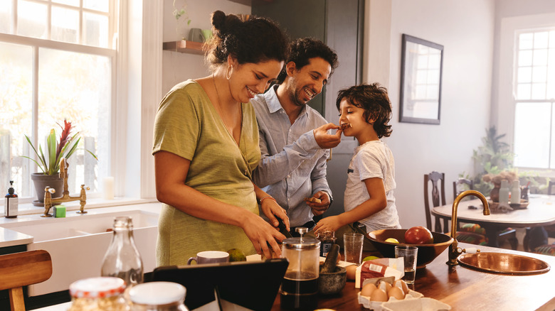 family playfully cooking