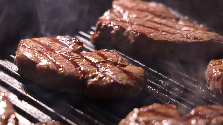 Steaks cooking on grill