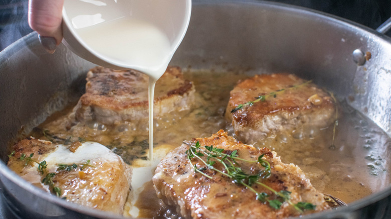 adding cream to chops