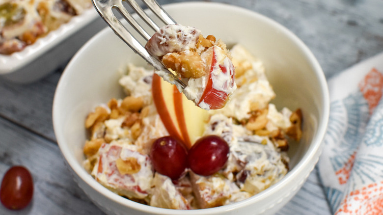 fork holding apple salad