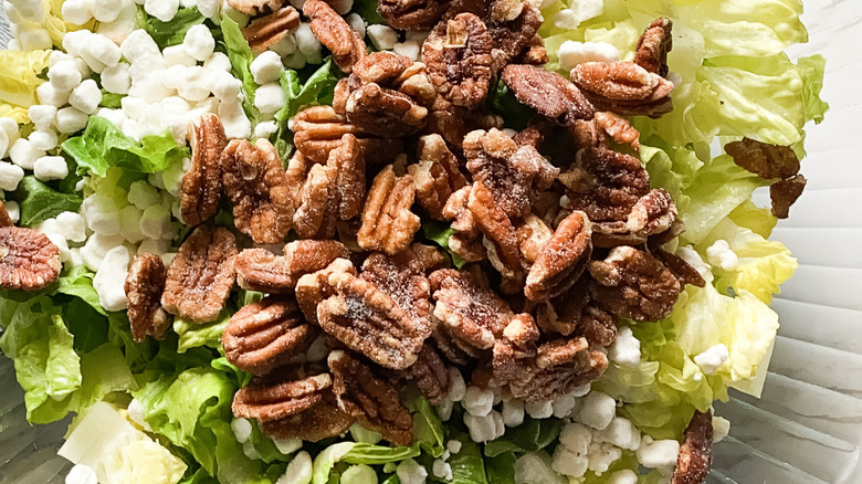 close-up of pecans atop salad