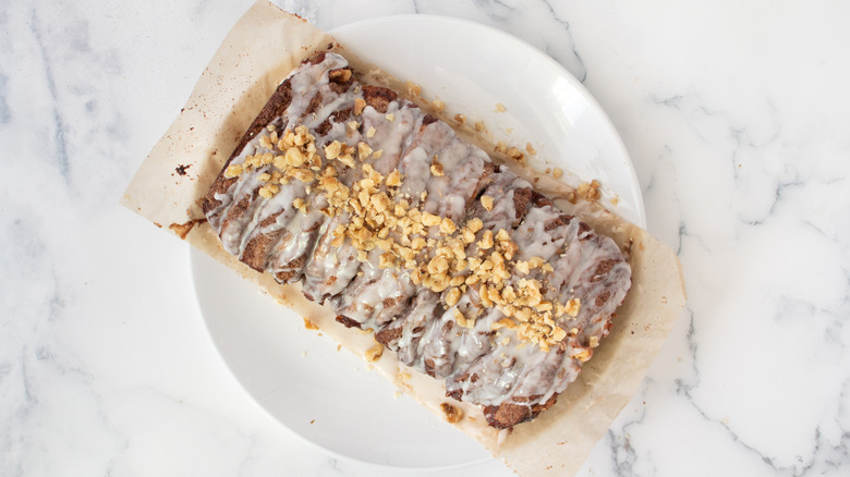 Pull-apart apple pie loaf with icing and walnuts