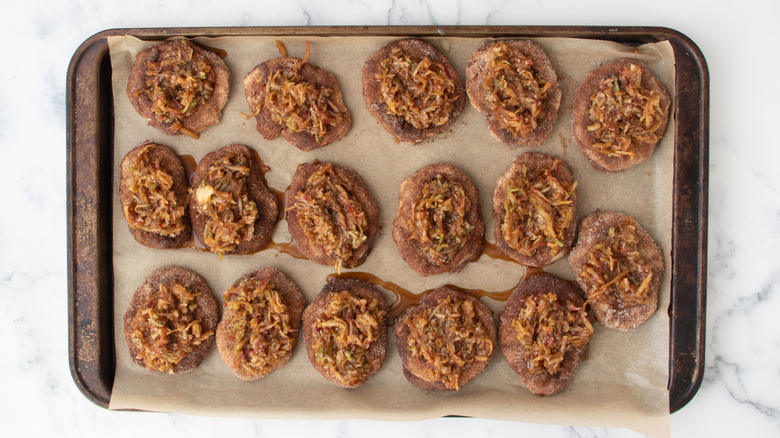 Sugar and apple mixture scooped onto biscuits