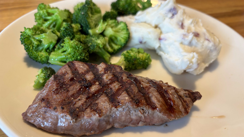 Steak on plate with broccoli and mashed potatoes