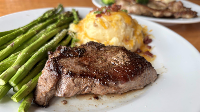 Steak on plate with asparagus and mashed potatoes