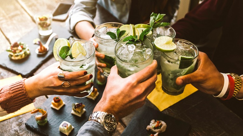 People toasting with cocktails