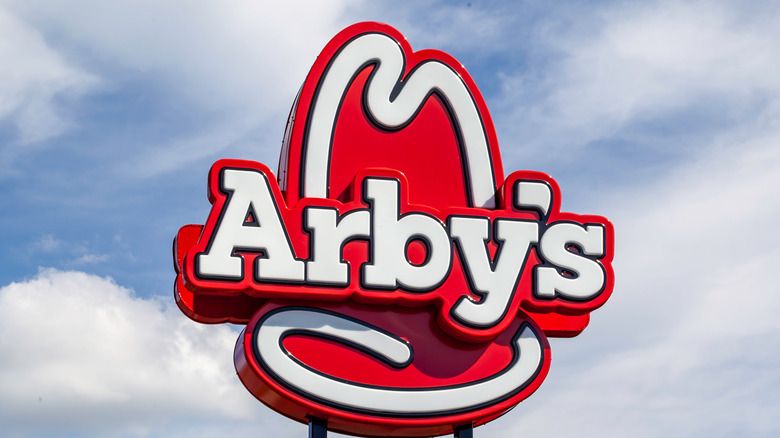 Arbys sign against blue sky