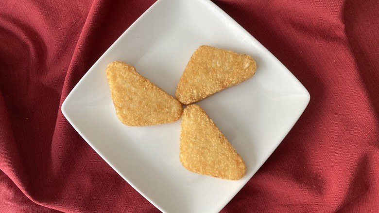 three Arby's potato cakes on plate