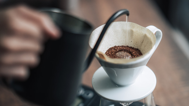 Barista brews pour-over coffee