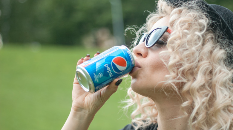 A woman drinking Pepsi 