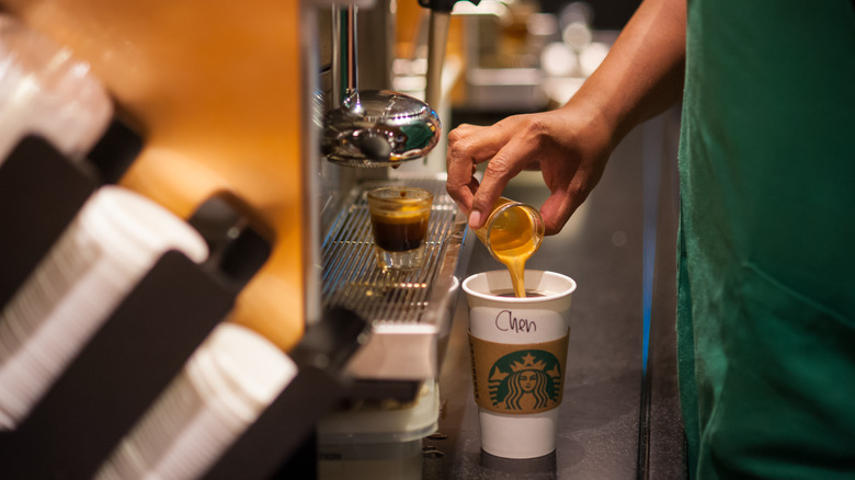 Starbucks barista making a coffee drink