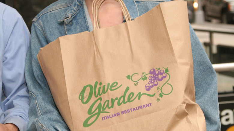 Person holding Olive Garden bag