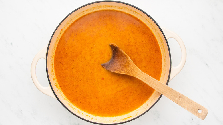 Coconut curry broth in casserole pot