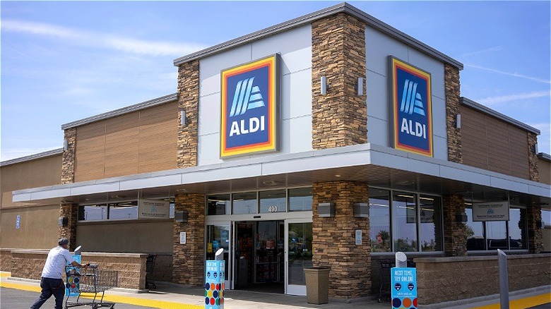 Aldi shopper outside store with cart