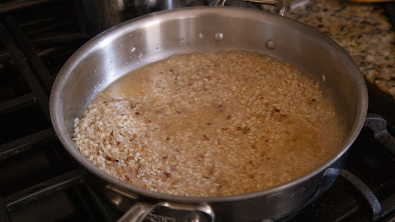 rice with broth in skillet