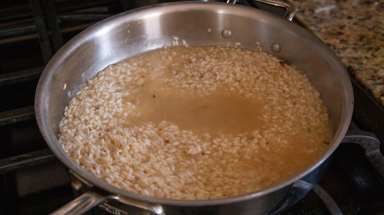 rice with broth in skillet