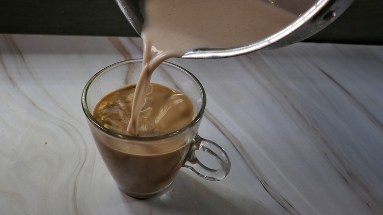 pouring cereal milk into coffee