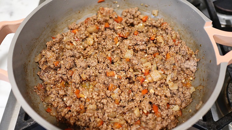 cooking empanada filling in skillet