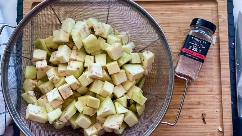 eggplant cubes in a colander with Himalayan salt