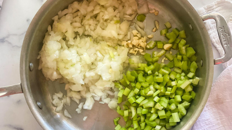 onions, garlic, and celery in a frying pan 