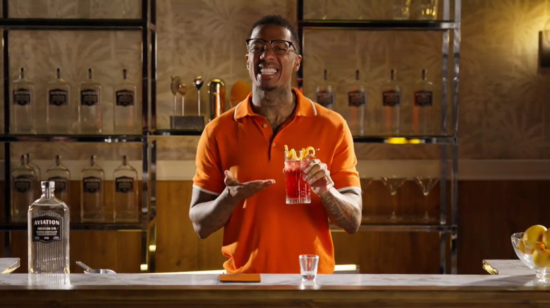 Nick Cannon holding a cocktail