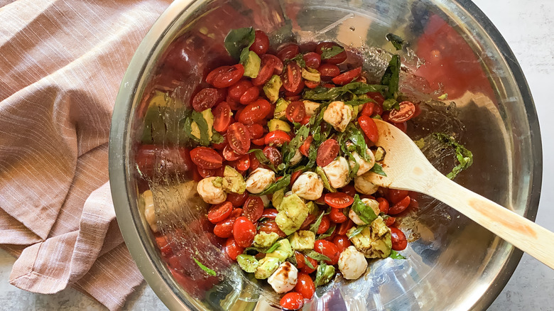 caprese salad mixed in bowl 