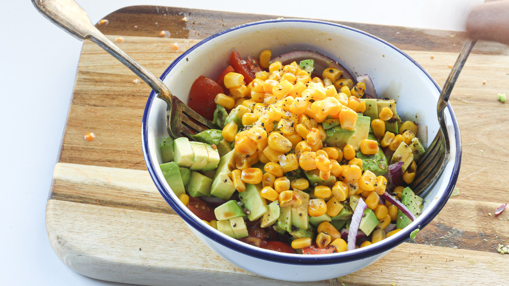 mixing salad in a bowl