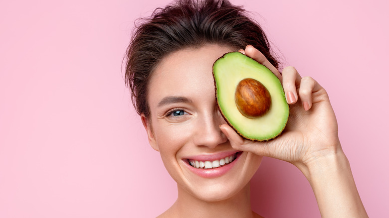 Woman holding avocado