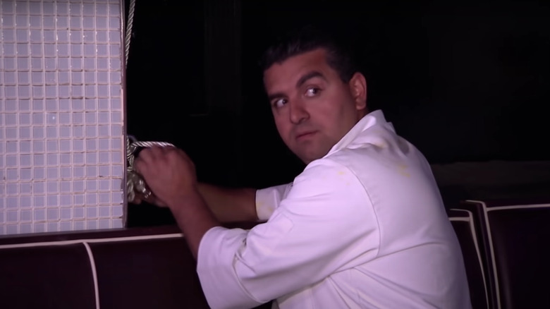 Buddy Valastro unhooking a chandelier cake