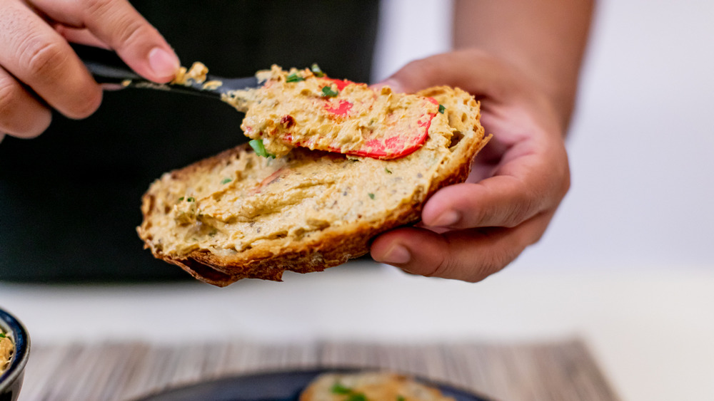 spreading baba ganoush on bread