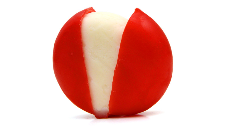 Unwrapped Babybel cheese white background