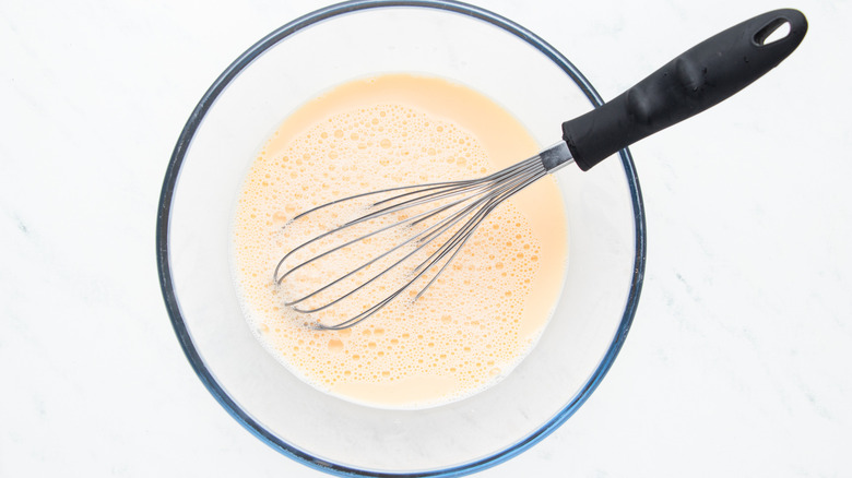 Milk and egg mixture whisked in bowl