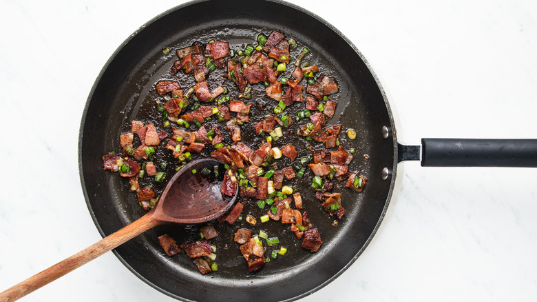 Bacon and green onion in frying pan