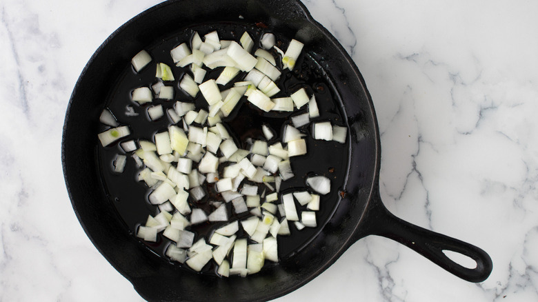 chopped onions in frying pan