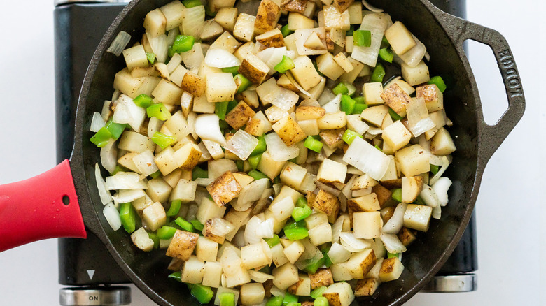 potatoes cooking in skillet