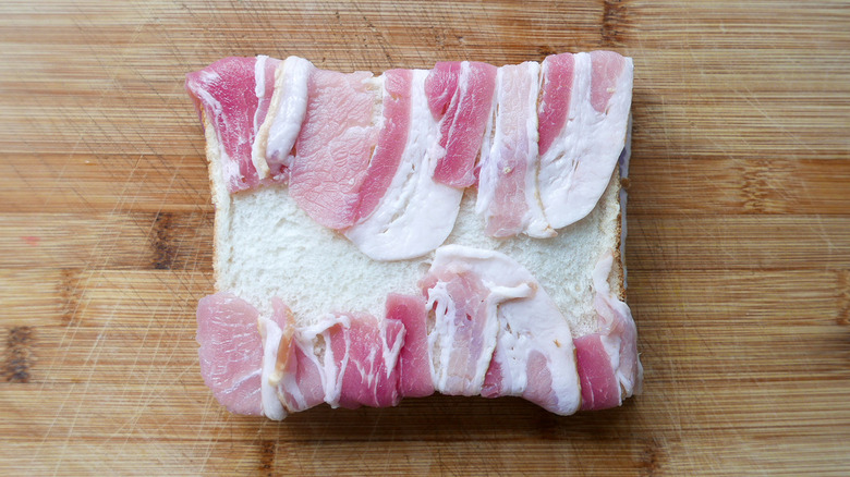 Bacon wrapped around white bread