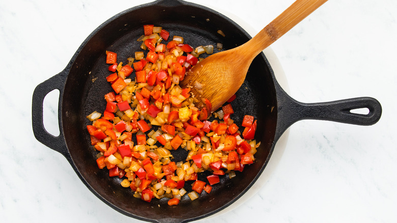 Onion, garlic, and red pepper frying in skillet