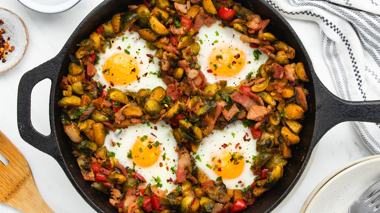 Brussels sprouts hash with eggs in skillet