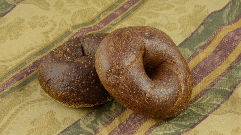 Pumpernickel bagels on tablecloth