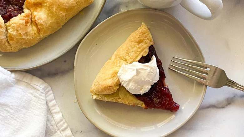 Plum pie slice with puff pastry and cream