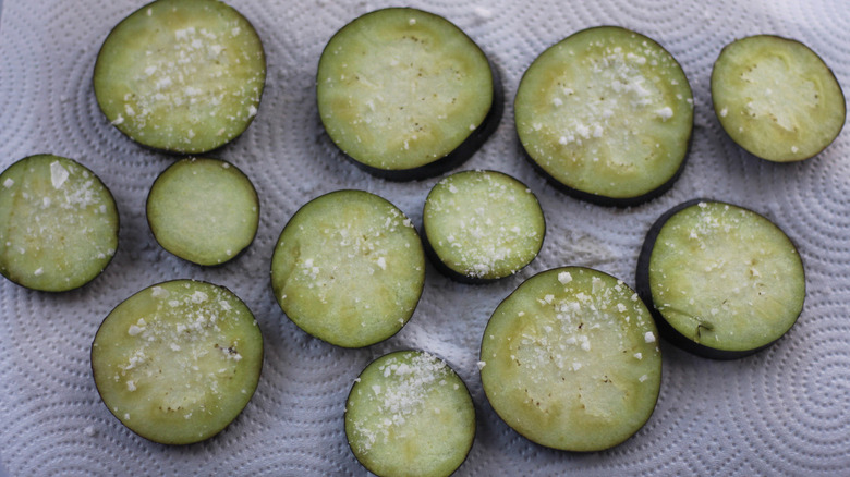 Eggplant discs sprinkled with salt.